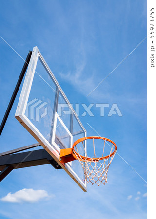 basketball board with basket hoop against blue sky 55923755