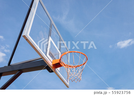 basketball board with basket hoop against blue sky 55923756