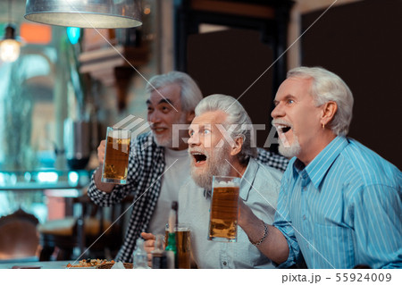 Fans feeling excited watching important football match Fans feeling excited watching important football match 55924009