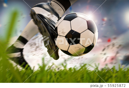 soccer player kicking soccer ball in motion 55925872