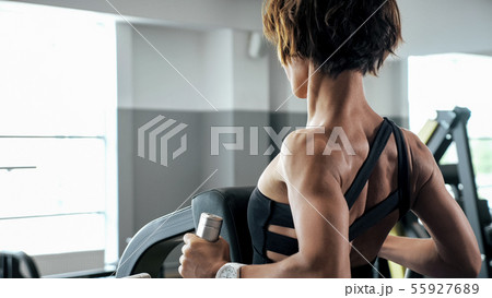 Sportive woman is doing exercises for spine muscles on block simulator Sportive woman is doing exercises for spine muscles on block simulator 55927689