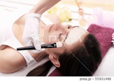 Spa concept. Young woman with nutrient facial mask in beauty salon, close up Spa concept. Young woman with nutrient facial mask in beauty salon, close up 55931486