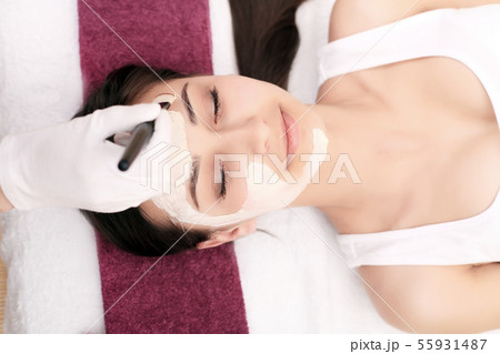 Spa therapy for young woman having facial mask at beauty salon - indoors Spa therapy for young woman having facial mask at beauty salon - indoors 55931487
