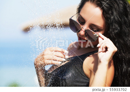 Beautiful Sexy Girl With Healthy Skin In Elegant Striped Bikini, Sun Hat Relaxing In Swimming Pool Beautiful Sexy Girl With Healthy Skin In Elegant Striped Bikini, Sun Hat Relaxing In Swimming Pool 55933702