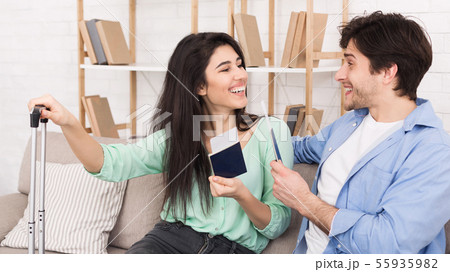 Happy couple with passports and tickets at home 55935982