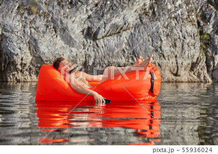Caucasian man sleeps on airsofa with phone. Caucasian man sleeps on airsofa with phone. 55936024