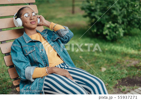 Young afro-american woman listening music in headset 55937271