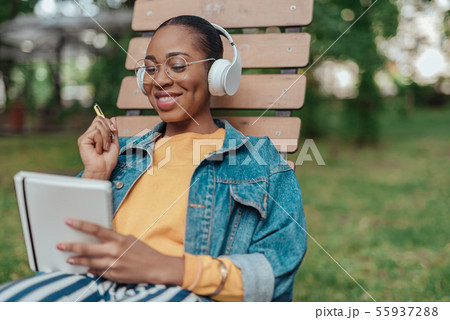 Young african american woman writing in notepad 55937288