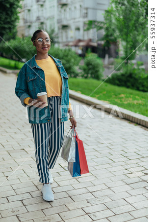 Young afro american woman is walking outdoors 55937314