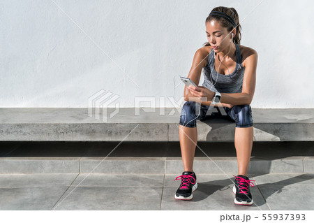 Fitness runner girl using music mobile phone app Fitness runner girl using music mobile phone app 55937393