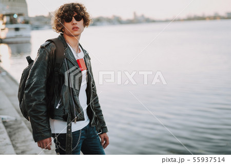 Young biker with backpack next to the river 55937514
