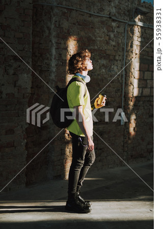 Young man in casual clothes against brick wall Young man in casual clothes against brick wall 55938331