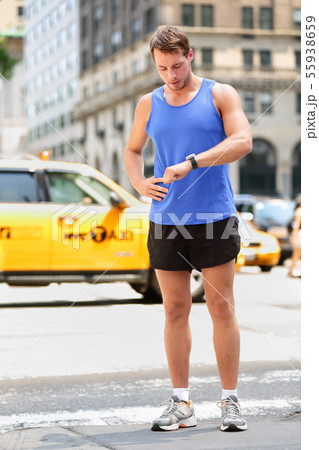 Runner looking at smart watch in New York City 55938659