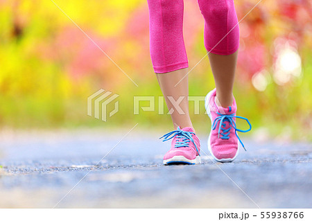 Jogging woman with athletic legs and running shoes 55938766