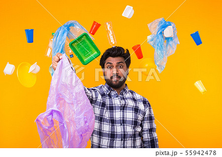 Environmental pollution, plastic recycling problem and waste disposal concept - surprised indian man 55942478