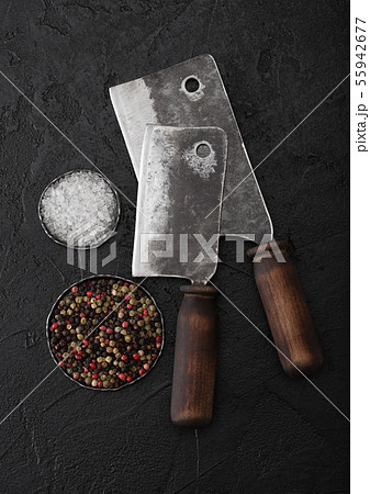 Vintage meat knife hatchets on black stone table Vintage meat knife hatchets on black stone table 55942677