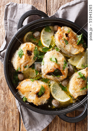 Baked cod steaks with lemon and olives closeup in Baked cod steaks with lemon and olives closeup in 55943265