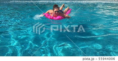 Young woman laughs happily smiling swims in Young woman laughs happily smiling swims in 55944006