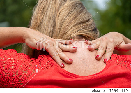 Cervical pain in a woman neck 55944419