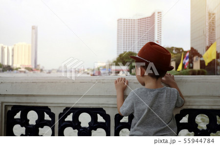 a boy stands with his back on the river. a boy stands with his back on the river. 55944784