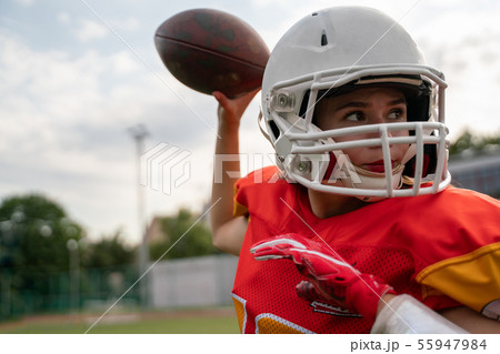 Photo of american football player woman throwing ball Photo of american football player woman throwing ball 55947984