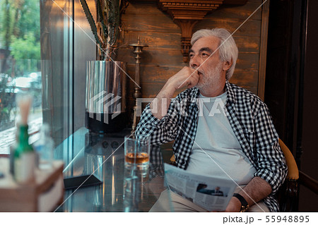 Bearded man feeling thoughtful after reading news 55948895