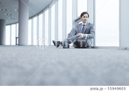 Businessman sitting on floor Businessman sitting on floor 55949603