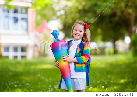 Little child with candy cone on first school day Little child with candy cone on first school day 55951741