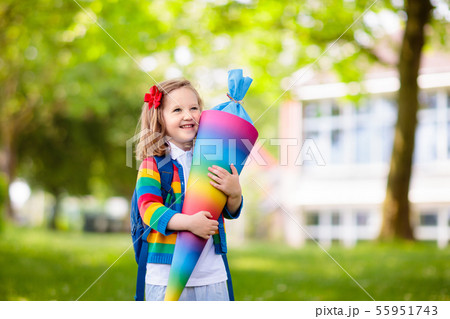 Little child with candy cone on first school day Little child with candy cone on first school day 55951743