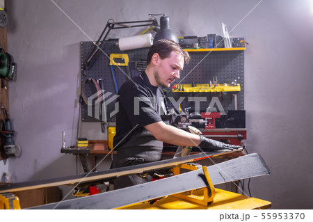 Repair, people concept - mechanic, man is rubbing a ski 55953370