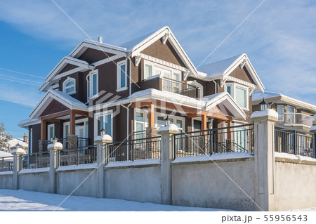 Luxurious residential house in snow on winter sunny day in Canada Luxurious residential house in snow on winter sunny day in Canada 55956543
