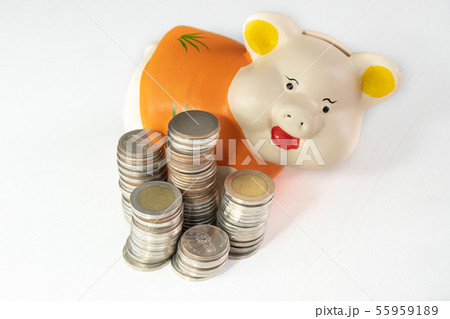 saving money with Orange piggy bank and coins pile saving money with Orange piggy bank and coins pile 55959189
