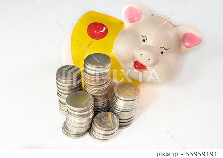 saving money with Yellow piggy bank and coins pile 55959191