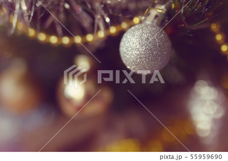 white brightening christmas ball close-up with yellow gerland on a branch in the Christmas and New white brightening christmas ball close-up with yellow gerland on a branch in the Christmas and New 55959690