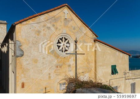 architecture of catholic church with a metal cross in the town of Portovenere on a sunny day, Italy architecture of catholic church with a metal cross in the town of Portovenere on a sunny day, Italy 55959697