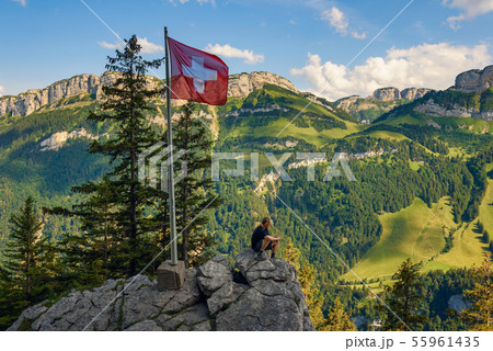 Tourist sitting on the Ebenalp mountain in the Swiss Alps of Switzerland 55961435