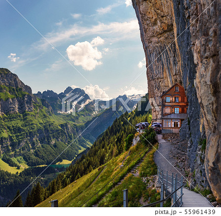 Swiss Alps and a restaurant under a cliff on mountain Ebenalp in Switzerland Swiss Alps and a restaurant under a cliff on mountain Ebenalp in Switzerland 55961439
