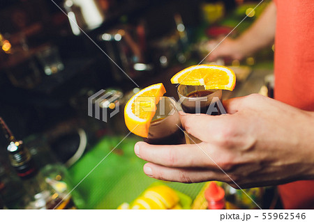 Jagermeister Shots cocktails with orange hand male. 55962546