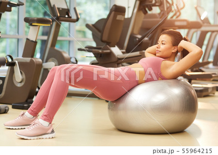 Beautiful Woman Working Out on Fitness Ball Beautiful Woman Working Out on Fitness Ball 55964215