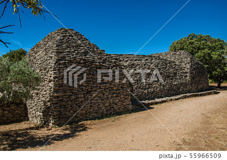 Path and stone huts in the Village of Bories 55966509