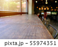 Wood table top with blur of people in coffee shop 55974351
