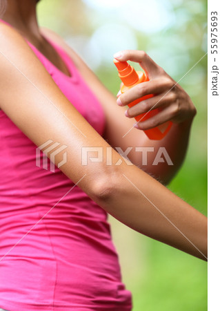 Mosquito repellent - woman using insect repellents Mosquito repellent - woman using insect repellents 55975693