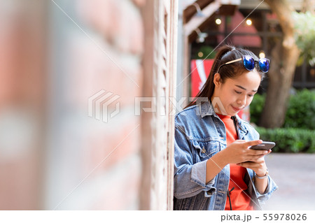 Woman with sunglasses on head, wearing a jacket, 55978026