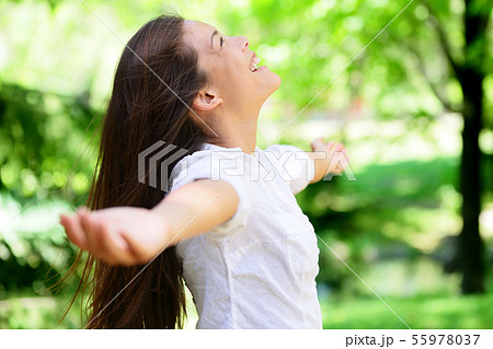 Joyful Woman With Arms Outstretched In Park Joyful Woman With Arms Outstretched In Park 55978037