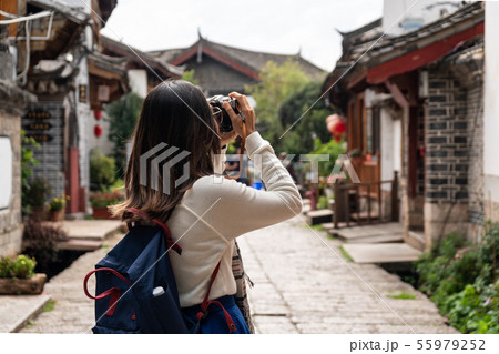 Young woman traveler walking and photographing at Young woman traveler walking and photographing at 55979252