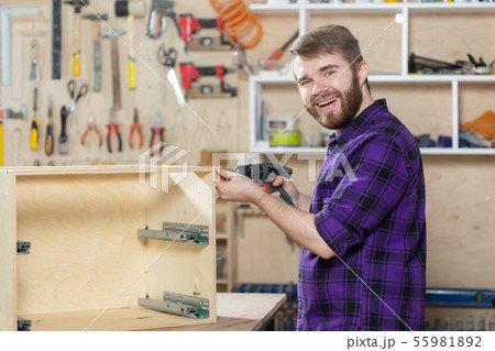 Manufacturing, Small-Sized Companies and worker concept - man working on the furniture factory 55981892