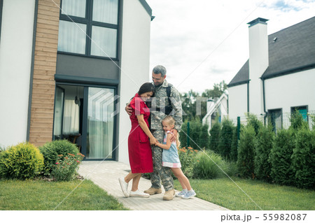 Family feeling happy and emotional after father returning home Family feeling happy and emotional after father returning home 55982087