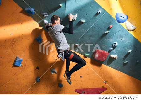 Physically challenged boulderer with muscular body shape trying to hold balance Physically challenged boulderer with muscular body shape trying to hold balance 55982657