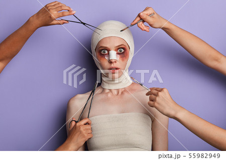 frightened girl wrapped into the bandage looking at the camera frightened girl wrapped into the bandage looking at the camera 55982949