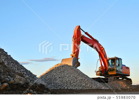 Large tracked excavator works in a gravel pit. Large tracked excavator works in a gravel pit. 55983070